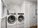 Bright laundry room featuring modern front load washer and dryer, and shiplap walls at 10479 Dusty Rose Dr, Zionsville, IN 46077