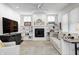 Inviting living room with a fireplace, built-in shelves, comfortable seating, and abundant natural light at 10479 Dusty Rose Dr, Zionsville, IN 46077