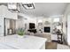 Bright, open living room with modern fireplace, built-in shelves, and island with marble countertop at 10479 Dusty Rose Dr, Zionsville, IN 46077