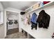 Mudroom with bench, coat hooks, storage shelves and access to the laundry room at 10479 Dusty Rose Dr, Zionsville, IN 46077