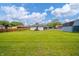 Sprawling backyard with green grass and a house in the background at 105 Golf Club Rd, Anderson, IN 46011