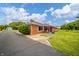 Brick home featuring a paved driveway and manicured landscaping at 105 Golf Club Rd, Anderson, IN 46011