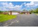 Ranch-style home boasts a brick facade, attached garage and long driveway at 105 Golf Club Rd, Anderson, IN 46011