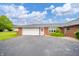 Brick ranch-style home has an attached garage and well-kept lawn at 105 Golf Club Rd, Anderson, IN 46011