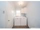 Laundry room with washer and dryer, overhead storage, and a bright window at 105 Golf Club Rd, Anderson, IN 46011