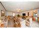 Cozy living room with comfortable seating, a ceiling fan, and wood paneling details at 105 Golf Club Rd, Anderson, IN 46011