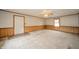 Spacious living room featuring wood paneling, patterned wallpaper, and a large window at 105 Golf Club Rd, Anderson, IN 46011