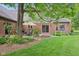 Lush green backyard showcasing a well-manicured lawn, mature trees, and a serene outdoor space at 1121 N Cambridge Ct, Greenfield, IN 46140
