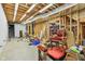 Unfinished basement with exposed beams, storage space, and stairs at 1121 N Cambridge Ct, Greenfield, IN 46140