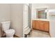 Neutral bathroom with a glass enclosed shower, wood vanity, and tiled floors at 1121 N Cambridge Ct, Greenfield, IN 46140