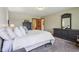 Inviting bedroom with carpet, neutral wall colors, a comfortable bed, and dark wood dressers and mirror for a relaxing retreat at 1121 N Cambridge Ct, Greenfield, IN 46140