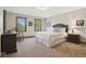Comfortable bedroom with two windows, a bed with white linens, and neutral decor at 1121 N Cambridge Ct, Greenfield, IN 46140