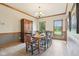 Traditional dining room featuring wood trim, a chandelier, and large windows offering pleasant views at 1121 N Cambridge Ct, Greenfield, IN 46140