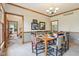 Elegant dining room showcases wood trim, wainscoting, a chandelier, and seating for six around a wooden table at 1121 N Cambridge Ct, Greenfield, IN 46140