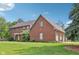 Beautiful brick home featuring a well-manicured lawn, an attached garage, and attractive landscaping at 1121 N Cambridge Ct, Greenfield, IN 46140