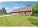 Spacious brick home featuring a three-car garage, lush green lawn, and well-maintained landscaping at 1121 N Cambridge Ct, Greenfield, IN 46140
