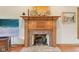 Close up of a classic brick fireplace with a wooden mantel, adding warmth and character to the living space at 1121 N Cambridge Ct, Greenfield, IN 46140