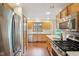 Spacious kitchen featuring stainless steel appliances, wood cabinets and floors, and natural light at 1121 N Cambridge Ct, Greenfield, IN 46140