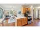 Bright kitchen showcasing wooden cabinets, stainless steel appliances, and an open layout into the living and dining areas at 1121 N Cambridge Ct, Greenfield, IN 46140