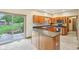 Spacious kitchen featuring wood cabinets, center island, stainless appliances, and a sliding glass door to the patio at 1121 N Cambridge Ct, Greenfield, IN 46140