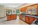 Well-lit kitchen featuring wood cabinetry, granite countertops, stainless steel appliances, and sliding glass doors at 1121 N Cambridge Ct, Greenfield, IN 46140