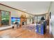 Cozy living room with hardwood floors, a brick fireplace, and large windows offering ample natural light at 1121 N Cambridge Ct, Greenfield, IN 46140