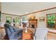 Bright and airy living room featuring hardwood floors, large windows, and comfortable seating arrangements at 1121 N Cambridge Ct, Greenfield, IN 46140