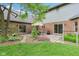 Charming backyard patio featuring an outdoor dining set, beautiful landscaping, and easy access to the home at 1121 N Cambridge Ct, Greenfield, IN 46140