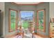 Relaxing sitting area with a rocking chair, large windows, and beautiful views of the landscaped backyard at 1121 N Cambridge Ct, Greenfield, IN 46140
