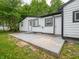 Home's backyard with a patio, lush green lawn, and landscaped garden at 1141 Temperance Ave, Indianapolis, IN 46203