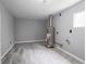 Unfinished basement featuring grey walls and wood-look flooring at 1141 Temperance Ave, Indianapolis, IN 46203