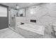 Elegant bathroom featuring a sleek shower, soaking tub, and marble tiled walls at 1141 Temperance Ave, Indianapolis, IN 46203