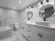 Contemporary bathroom with marble tile, double vanity, and modern lighting at 1141 Temperance Ave, Indianapolis, IN 46203