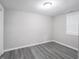 Cozy bedroom featuring neutral walls, grey flooring and natural light from window at 1141 Temperance Ave, Indianapolis, IN 46203