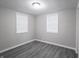 Empty bedroom with grey wood-look flooring, neutral paint and natural light at 1141 Temperance Ave, Indianapolis, IN 46203
