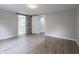 Spacious bedroom featuring wood flooring and an ensuite bathroom with modern sliding door at 1141 Temperance Ave, Indianapolis, IN 46203
