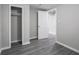 Empty bedroom with grey wood-look flooring, closet and neutral paint at 1141 Temperance Ave, Indianapolis, IN 46203