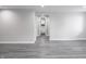 Hallway leading to a bathroom featuring gray walls, gray flooring, and white doors at 1141 Temperance Ave, Indianapolis, IN 46203