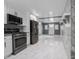 Open concept kitchen featuring stainless steel appliances and tile flooring throughout at 1141 Temperance Ave, Indianapolis, IN 46203