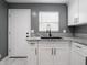 Updated kitchen showcases granite countertops, stylish fixtures, and white cabinets at 1141 Temperance Ave, Indianapolis, IN 46203