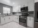 Modern kitchen with stainless steel appliances, sleek cabinets and granite countertops at 1141 Temperance Ave, Indianapolis, IN 46203