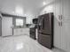 Updated kitchen features modern stainless steel appliances, white cabinetry, and recessed lighting at 1141 Temperance Ave, Indianapolis, IN 46203