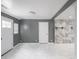 Spacious living room with tiled floors, gray walls, and a decorative wall at 1141 Temperance Ave, Indianapolis, IN 46203