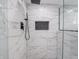 Modern shower with sleek black fixtures and stylish marble tile surround at 1141 Temperance Ave, Indianapolis, IN 46203