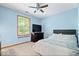 A blue bedroom includes a TV, closet, ceiling fan, and views of outside at 11956 Glen Cove Dr, Indianapolis, IN 46236