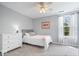 Cozy bedroom showcases neutral tones, a ceiling fan, and a window offering natural light and views of outdoors at 11956 Glen Cove Dr, Indianapolis, IN 46236