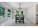 Elegant dining room with large windows and modern light fixture at 11956 Glen Cove Dr, Indianapolis, IN 46236