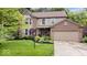 Charming two-story home with brick and siding, lush landscaping, and attached two-car garage at 11956 Glen Cove Dr, Indianapolis, IN 46236