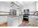 Modern kitchen with stainless steel appliances, granite countertops, island, and white cabinets at 11956 Glen Cove Dr, Indianapolis, IN 46236