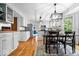 Well-lit kitchen featuring stainless steel appliances, white cabinets, and an eat-in dining area at 11956 Glen Cove Dr, Indianapolis, IN 46236
